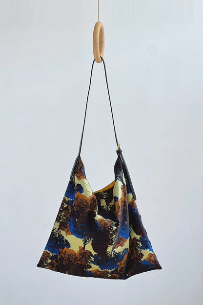 The Silk Bag — colourful painting-print shoulder bag hanging on hook