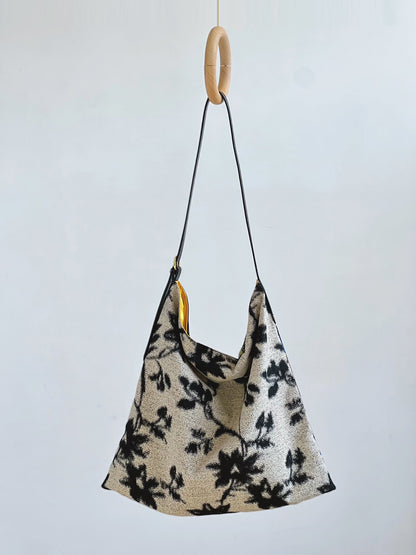 The Silk Bag — black-and-white floral side of bag hanging on hook