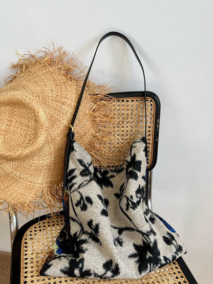 The Silk Bag — floral bag arranged with straw hat
