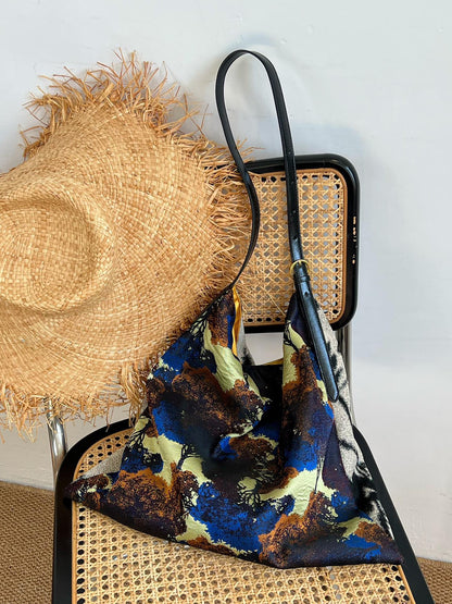 The Silk Bag — colourful bag arranged with straw hat