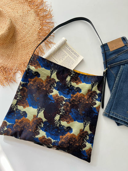 The Silk Bag — colourful bag beside book and denim