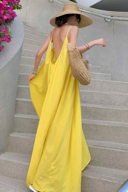 Bright Beach Holiday Dress — model wearing bright yellow holiday dress on steps