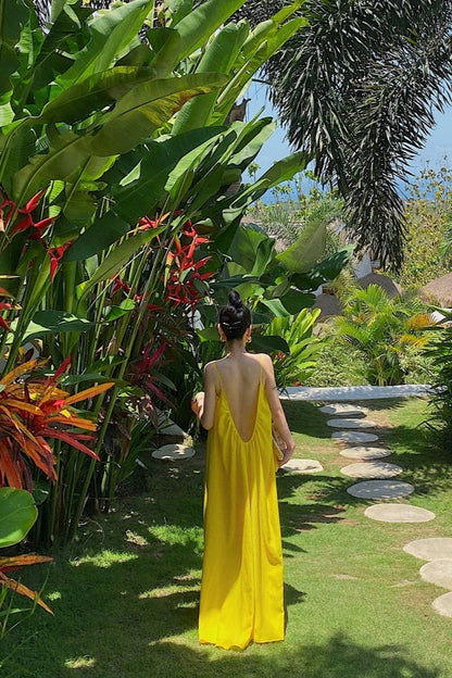 Bright Beach Holiday Dress — yellow holiday dress worn in tropical garden