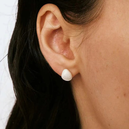 The Shell-Ear Stud — side view of shell-shaped stud worn on an ear