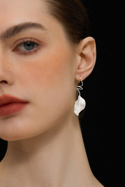 The Leaves -Earrings — close-up of silver-tone leaf earring worn on an ear