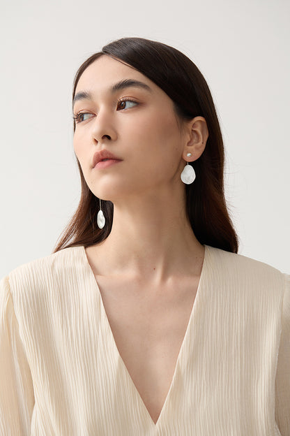The Dune — model wearing silver-tone oval drop earrings